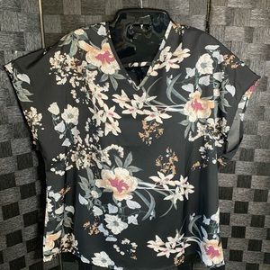 NWOT Black short sleeve blouse with beautiful flowers. 100% Polyester size Large
